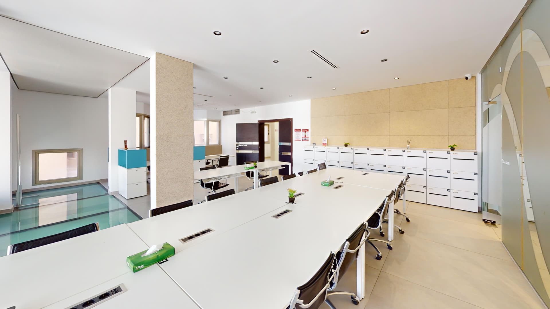 Shared area with long tables and personal lockers