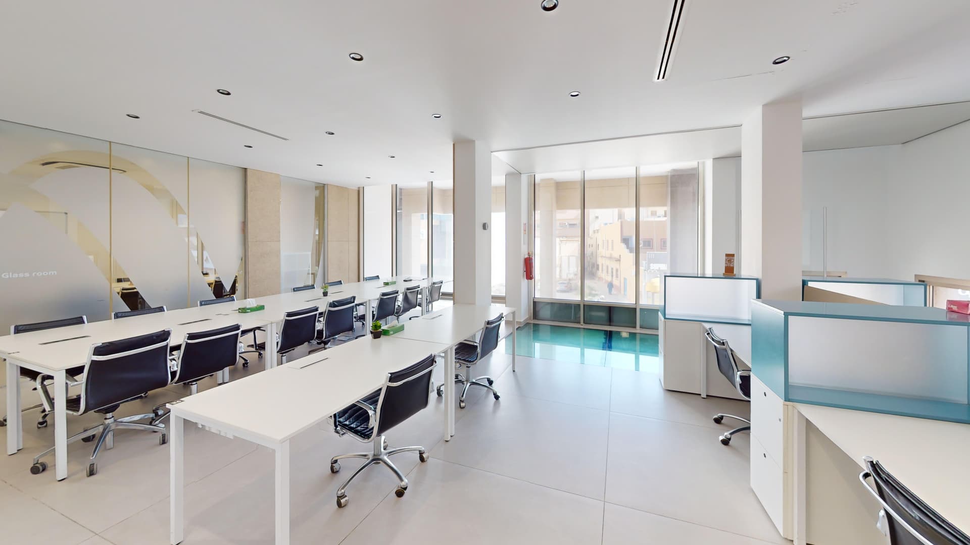 Shared space with communal desks and natural light