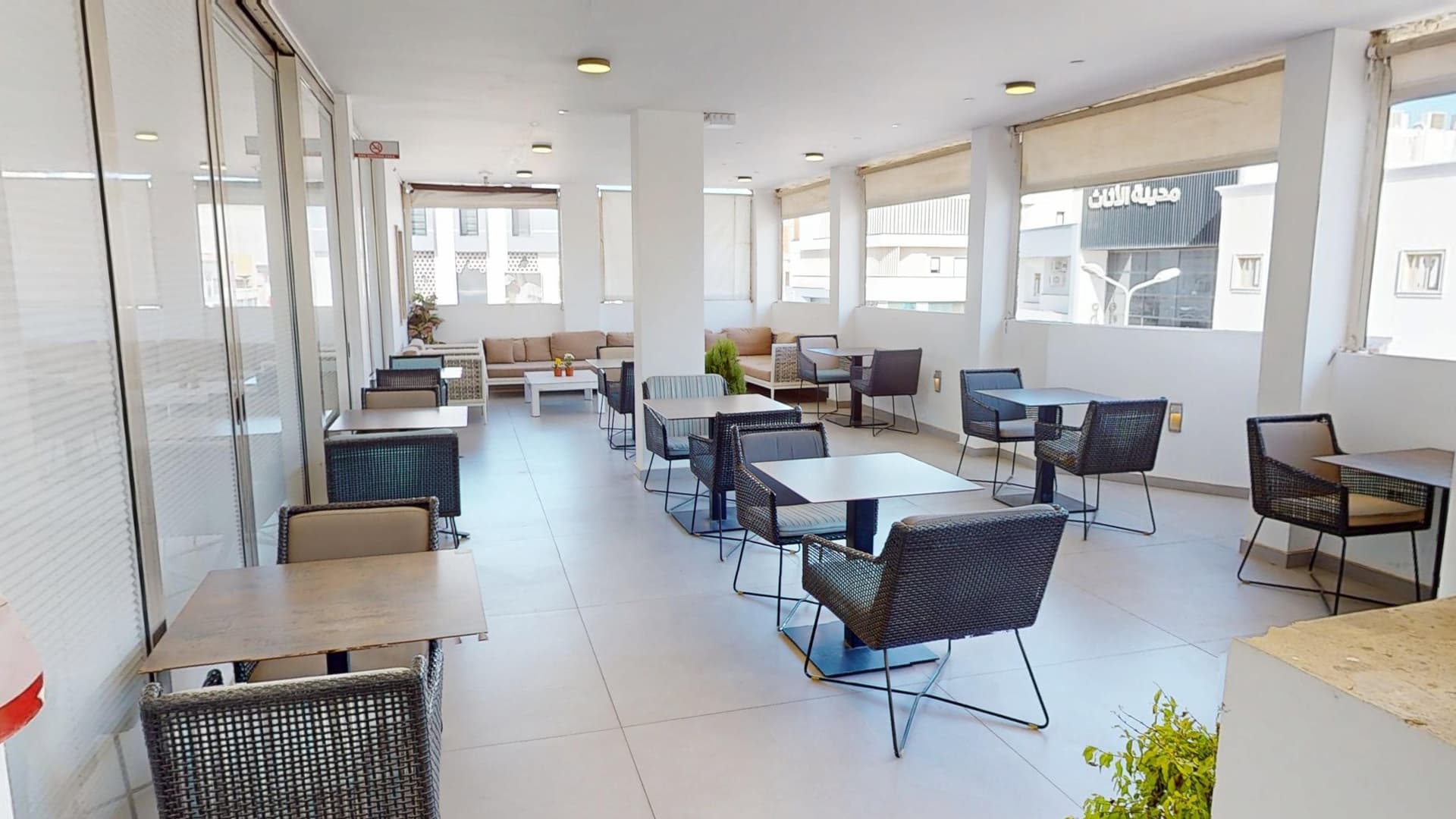 Terrace lounge area with sofas and tables