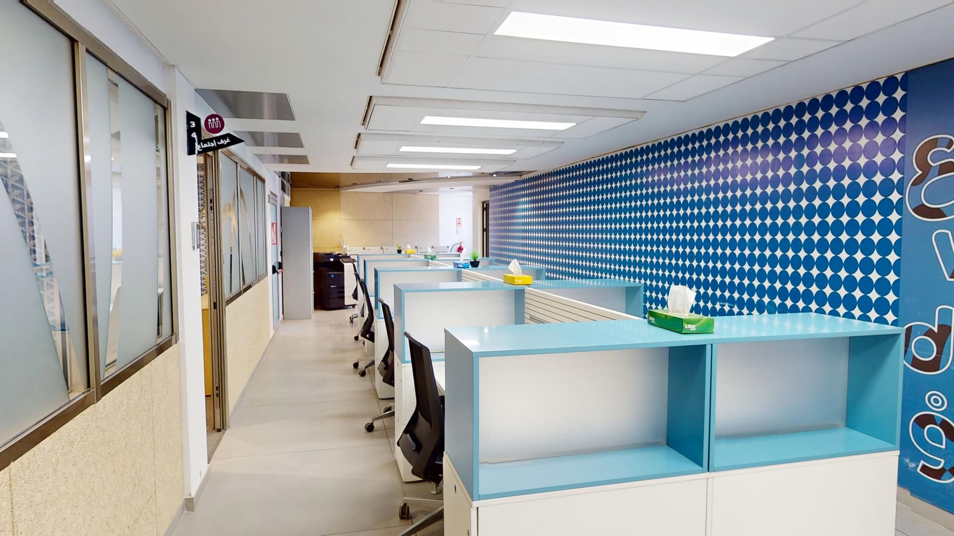 Workstations with privacy separators and colorful wall mural