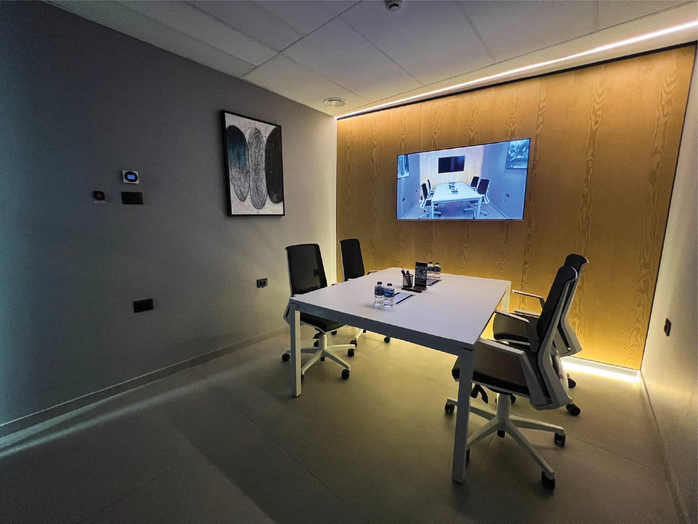 Focus Room - 4-seat setup with ambient lighting and TV showing room view