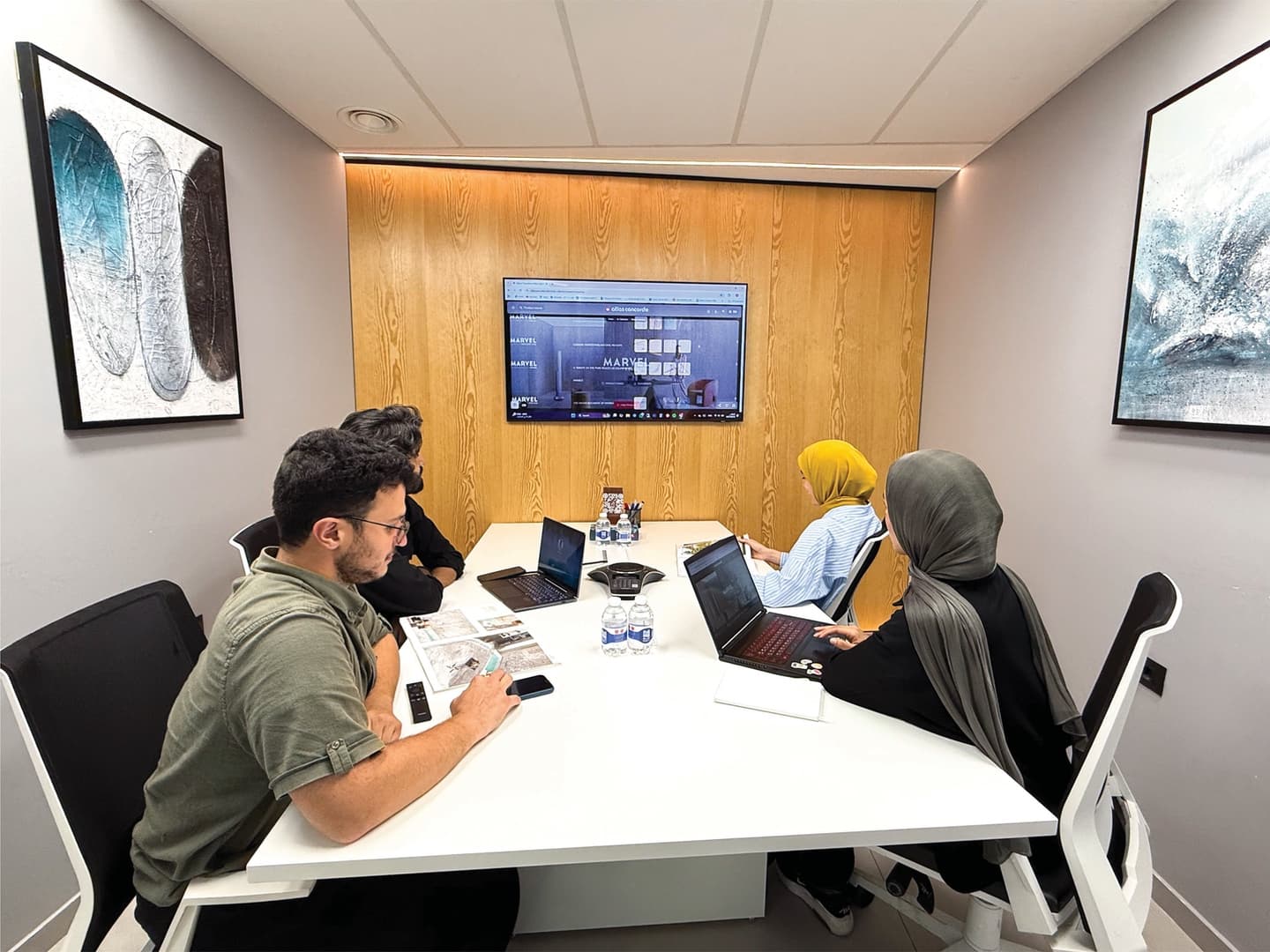 Focus Room - team collaborating with laptops around table