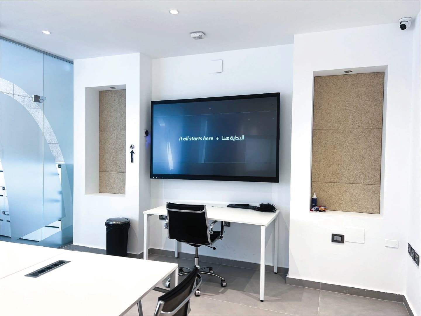 Glass Room - presenter desk with large display and acoustic panels