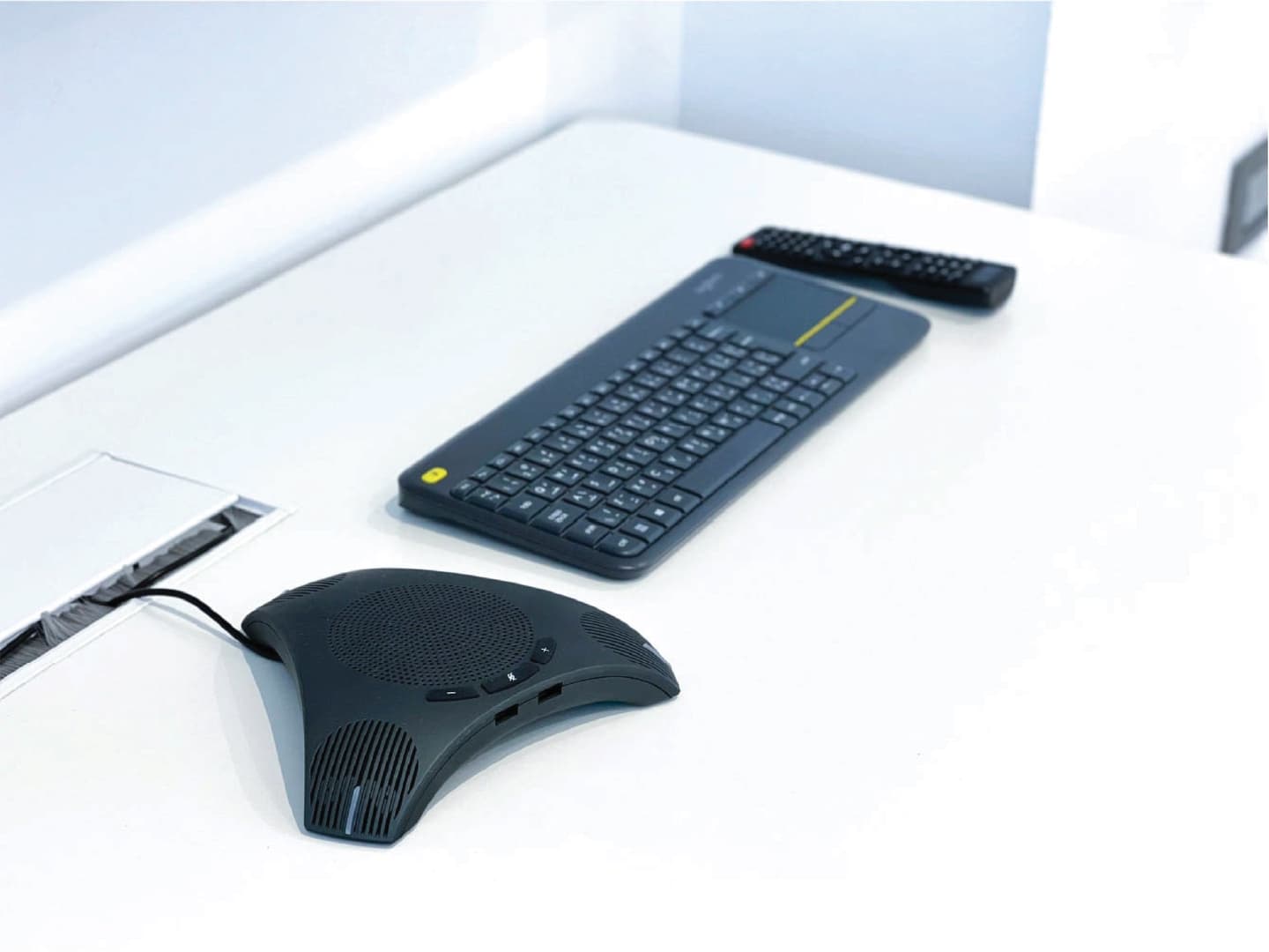 Glass Room - conference speakerphone, keyboard and remote control