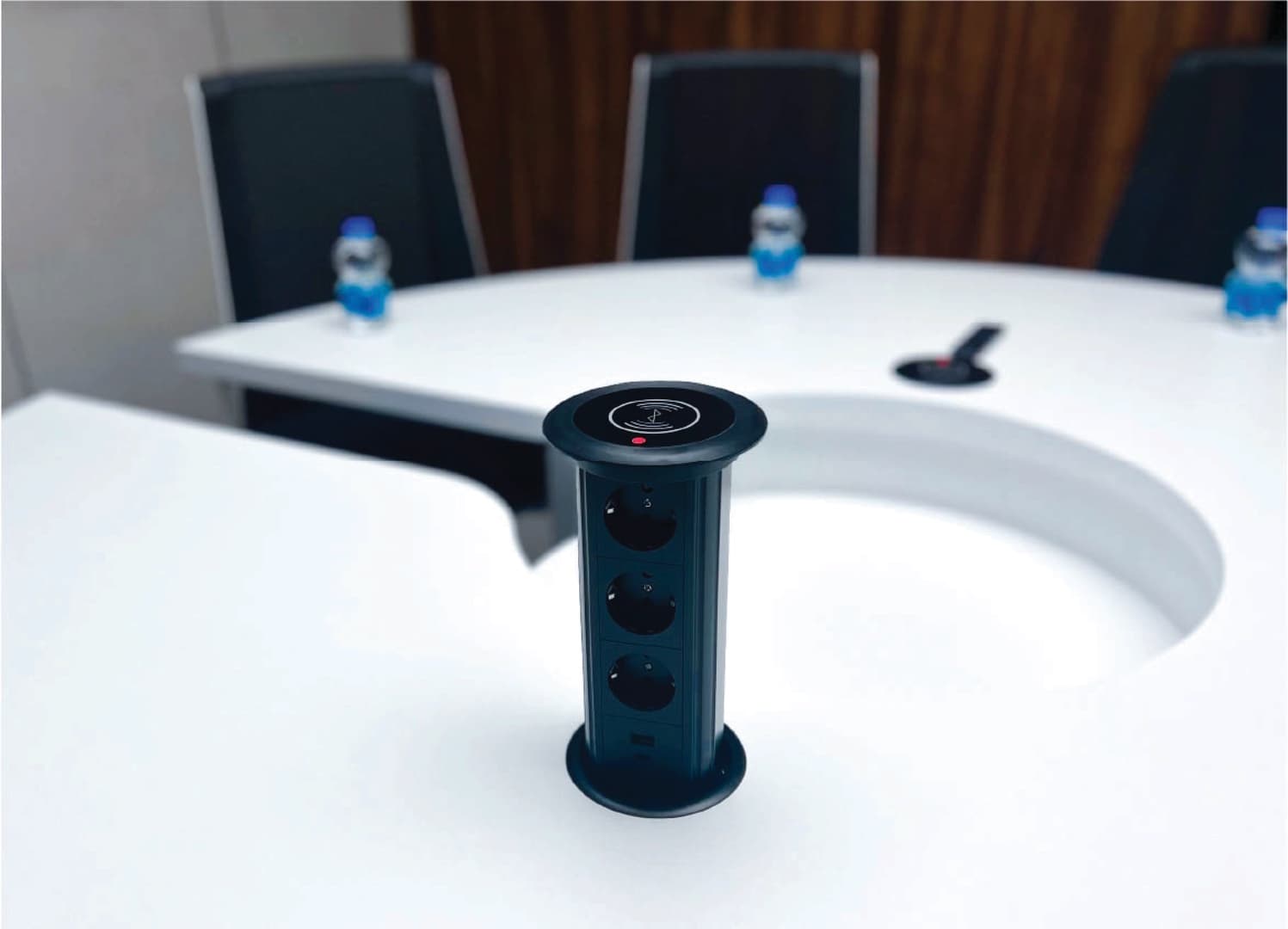 Round Room - pop-up power tower with wireless charging and outlets