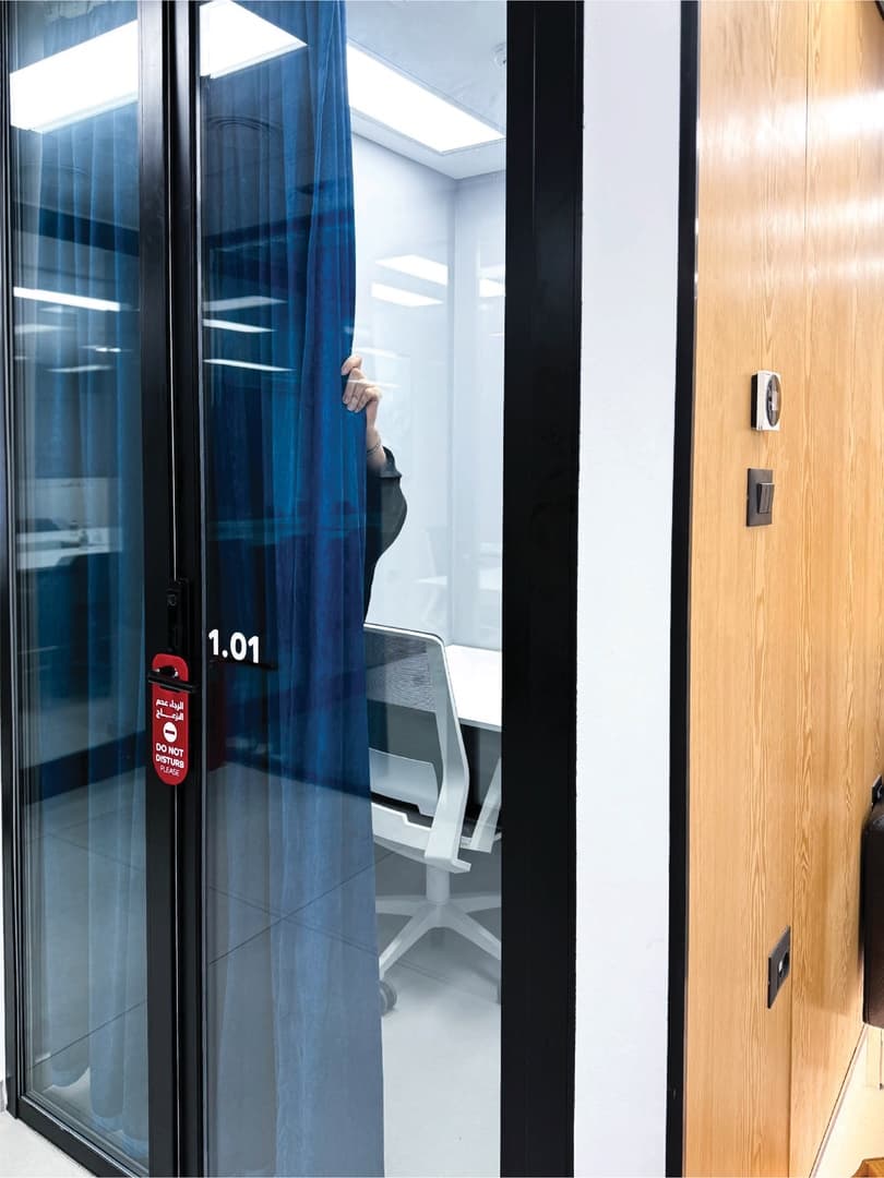 Single Room - glass door entrance with blue curtain and room number 1.01