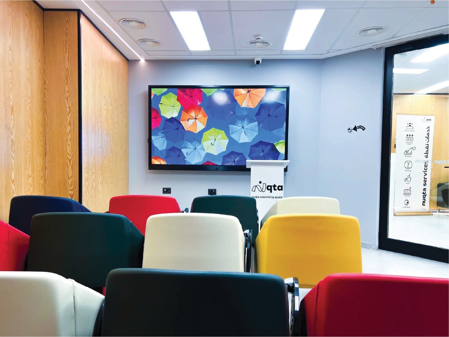 Stage Room - colorful seating with display and Nuqta podium