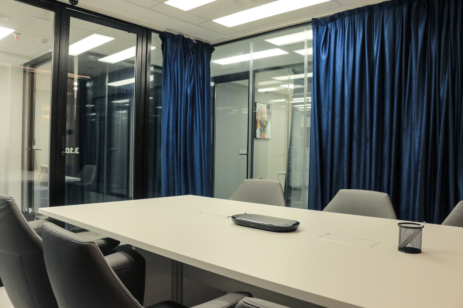 Superior Room - white table with blue curtains and glass walls