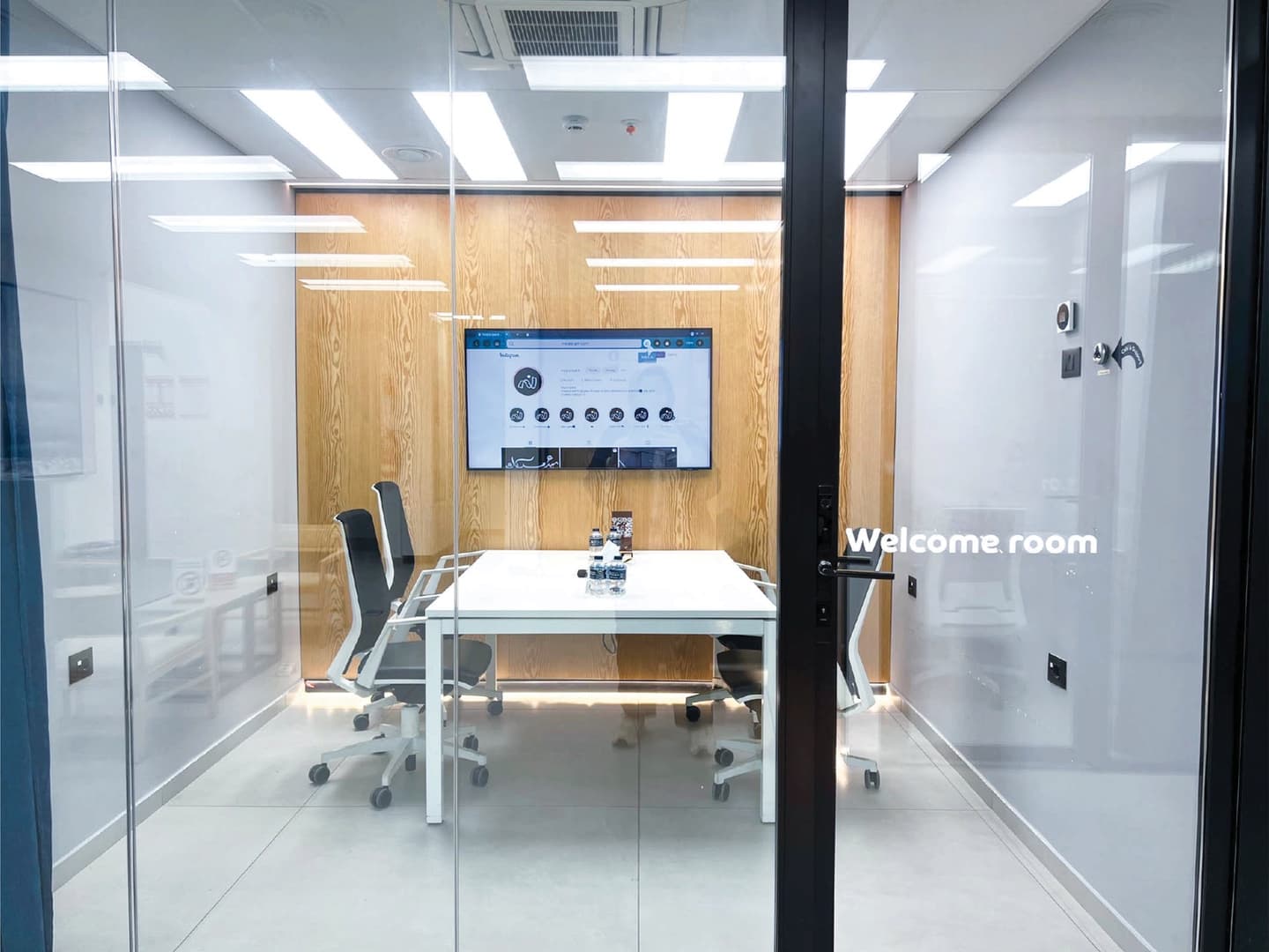 Welcome Room - glass door exterior with room name and view of interior