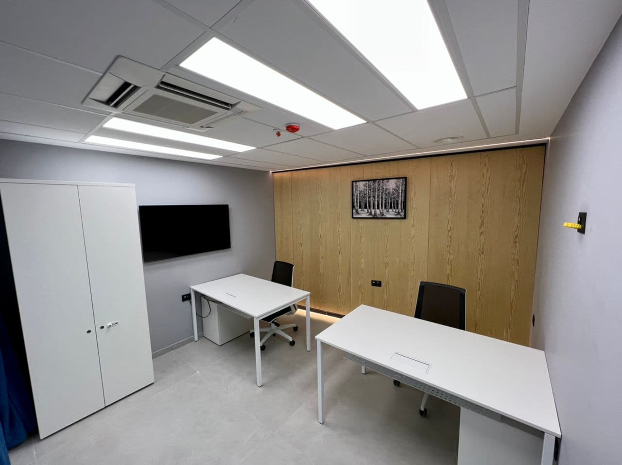 Private office with wooden wall and framed artwork